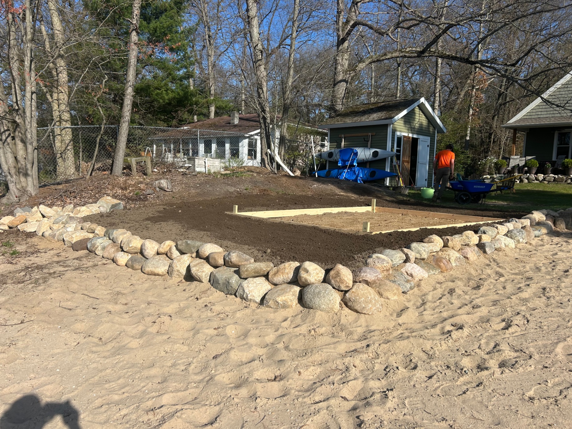 Property project in progress with stone border and prepared ground
